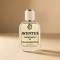 Perfume bottle labeled 'Aventus Impression by Fragranceive Scents' on a beige background